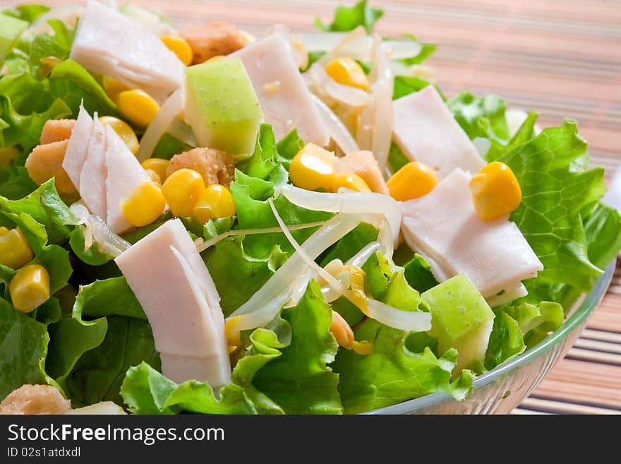 Corn salad with green lettuce and ham