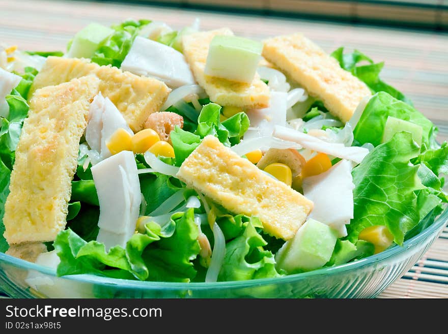 Corn salad with green lettuce and ham