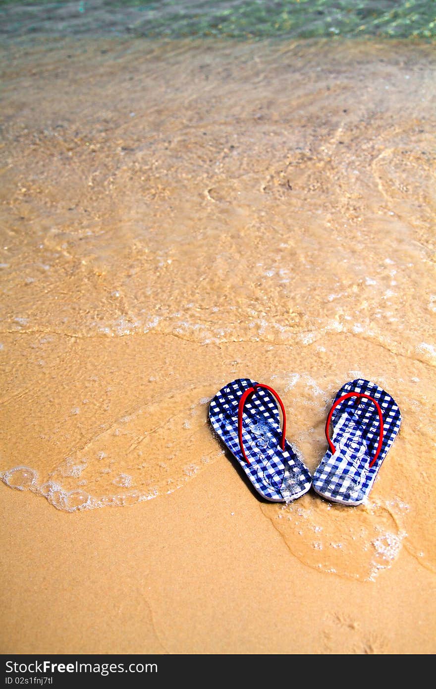 Checked flip-flops on the beach