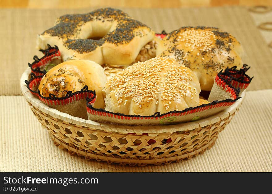 Basket full of various buns with seeds and herbs. Basket full of various buns with seeds and herbs