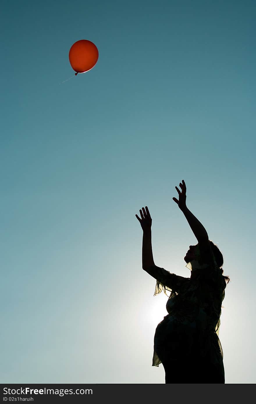 A silhouette of a pregnant woman