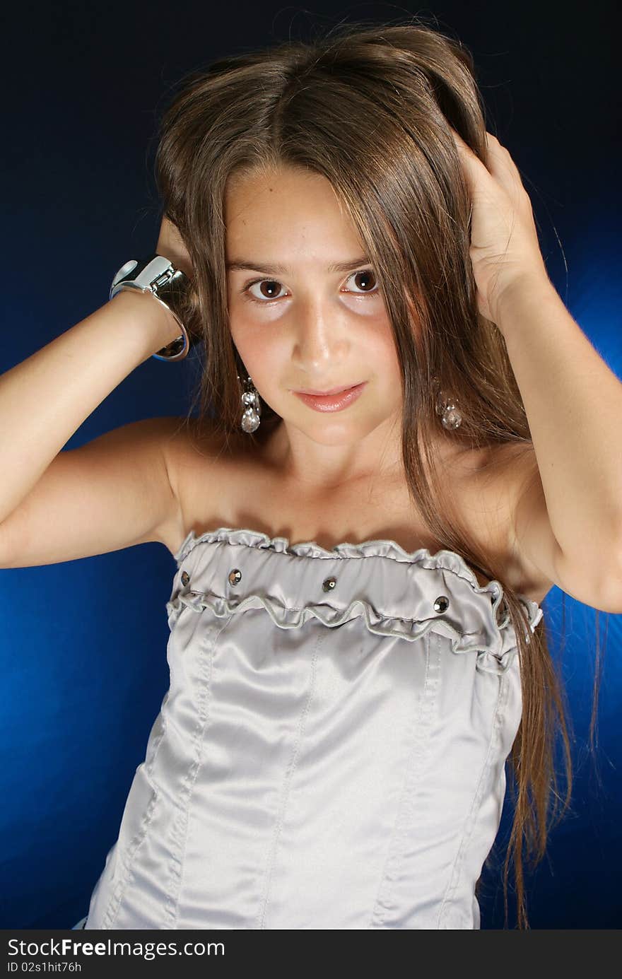 Young girl posing with hands in her hair