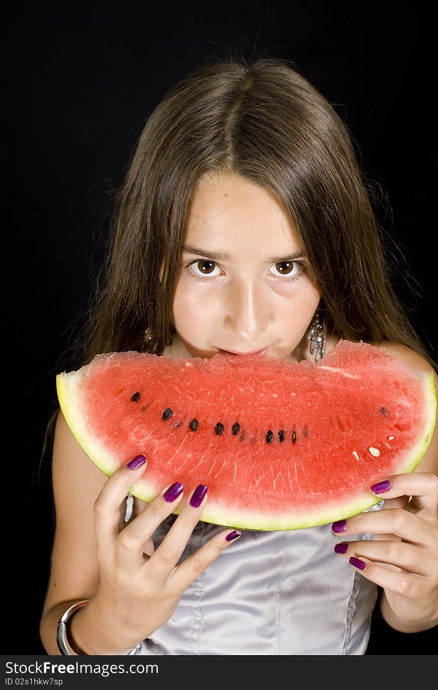 Girl eating Watermelon on black background