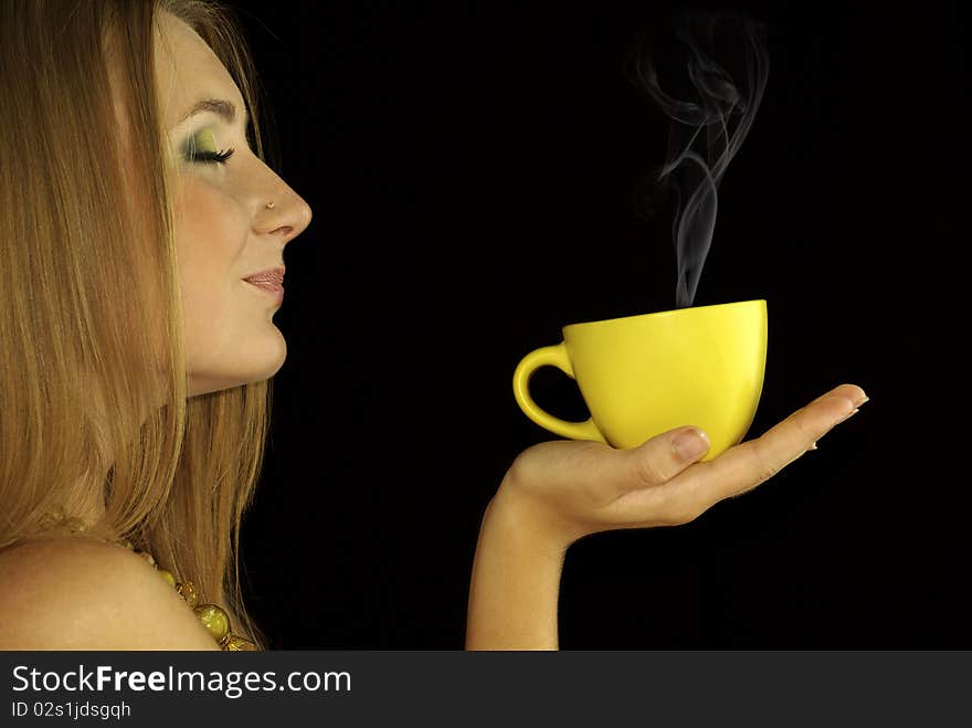 Portrait of a beautiful sexual girl with a cup of hot drink in hand, isolation on a black background. Portrait of a beautiful sexual girl with a cup of hot drink in hand, isolation on a black background