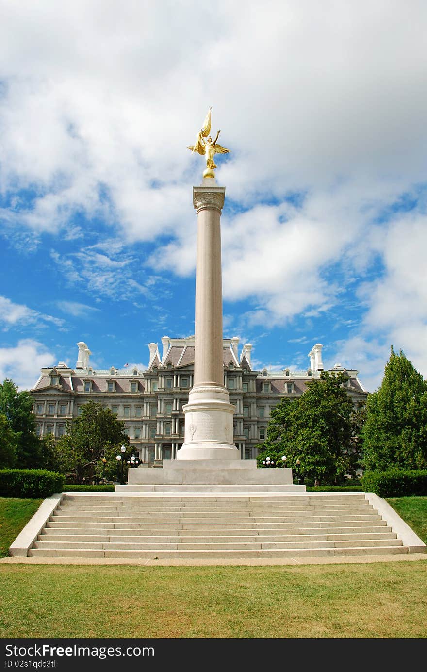 A photo of a First Division Monument on the National Mall in the Washington D.C., USA, with the Eisenhower Executive Office Building in a background. A photo of a First Division Monument on the National Mall in the Washington D.C., USA, with the Eisenhower Executive Office Building in a background.