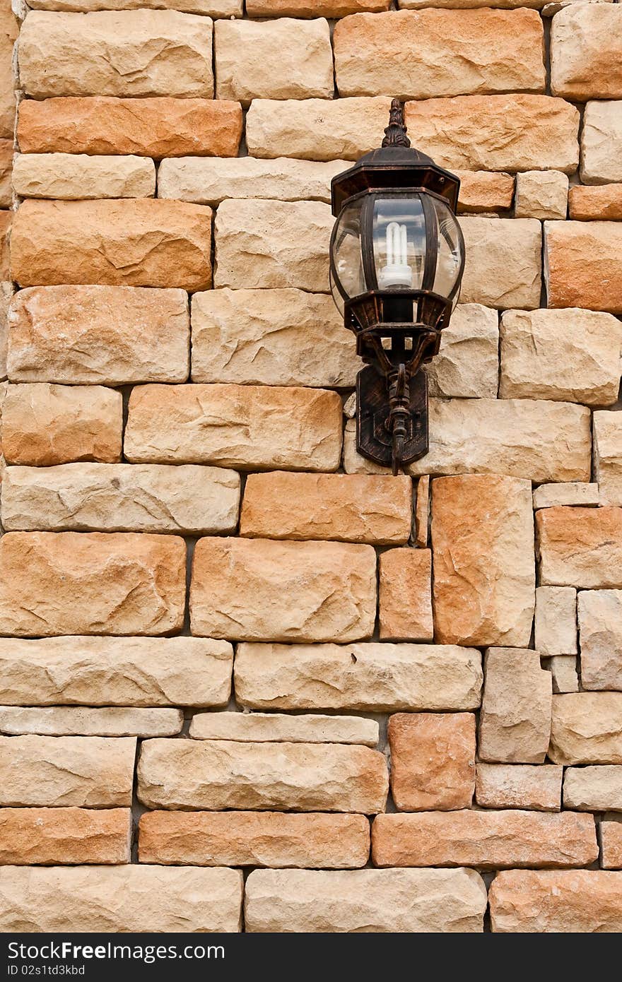 Lantern on rough brick wall