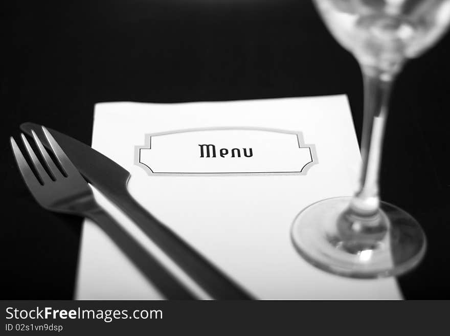 Silverware and a menu on a restaurant table