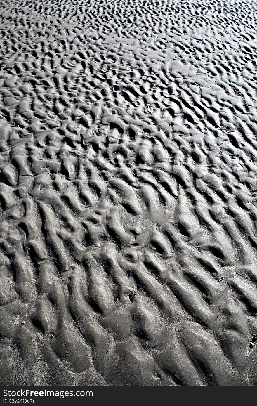 Erosion shapes caused by tidal waters on beach sand. Erosion shapes caused by tidal waters on beach sand