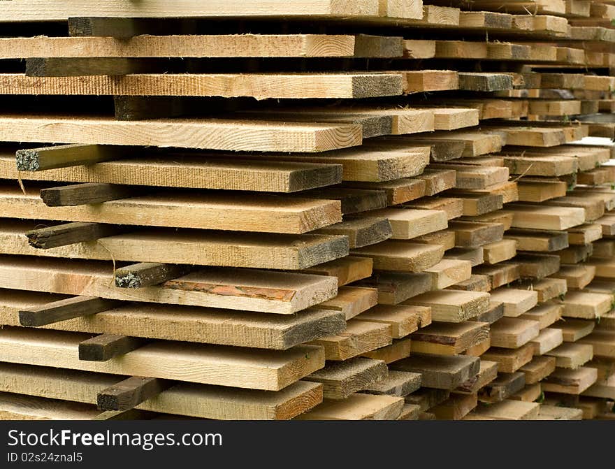 Corner of a stack of wooden boards. Corner of a stack of wooden boards.