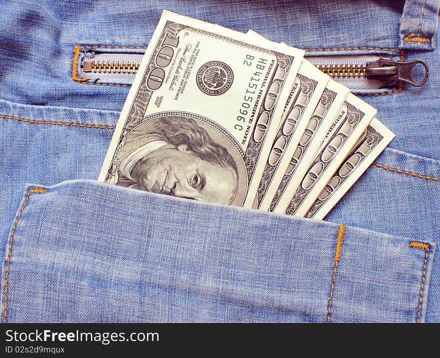 Blue jeans pocket with many one hundred dollars banknotes. Blue jeans pocket with many one hundred dollars banknotes