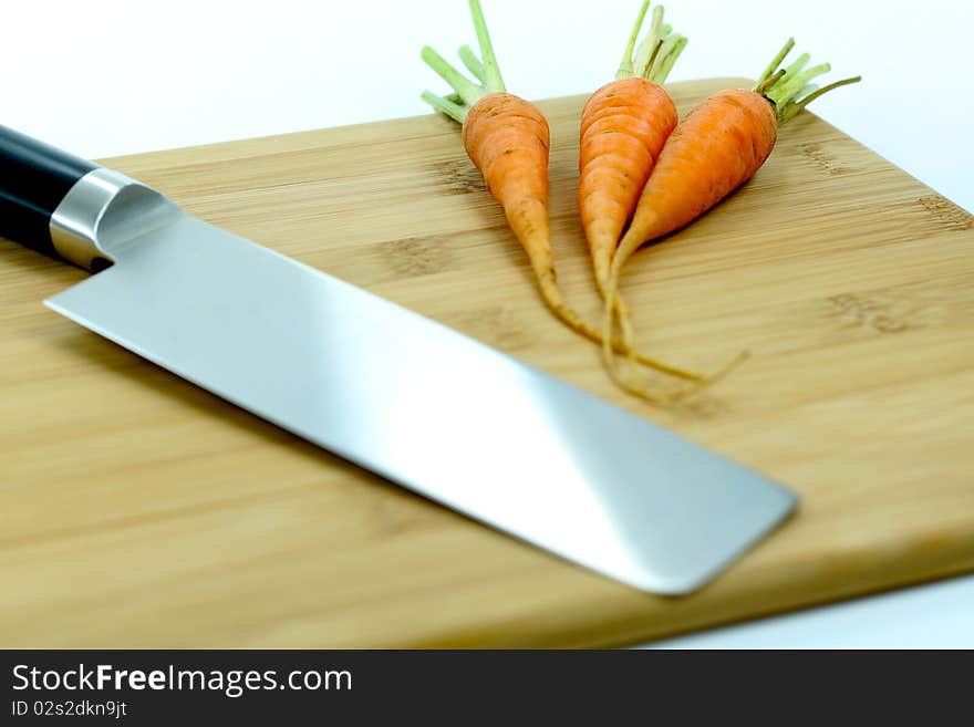 A picture of japanese knife and carrots