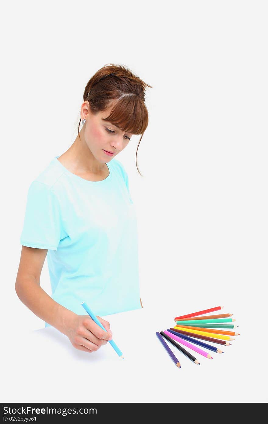 A woman drawings with colorful pencils isolated on a white background. A woman drawings with colorful pencils isolated on a white background