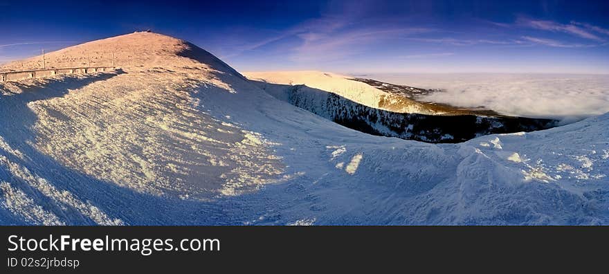 Stitched Panorama, winter sunrise in the mountains.