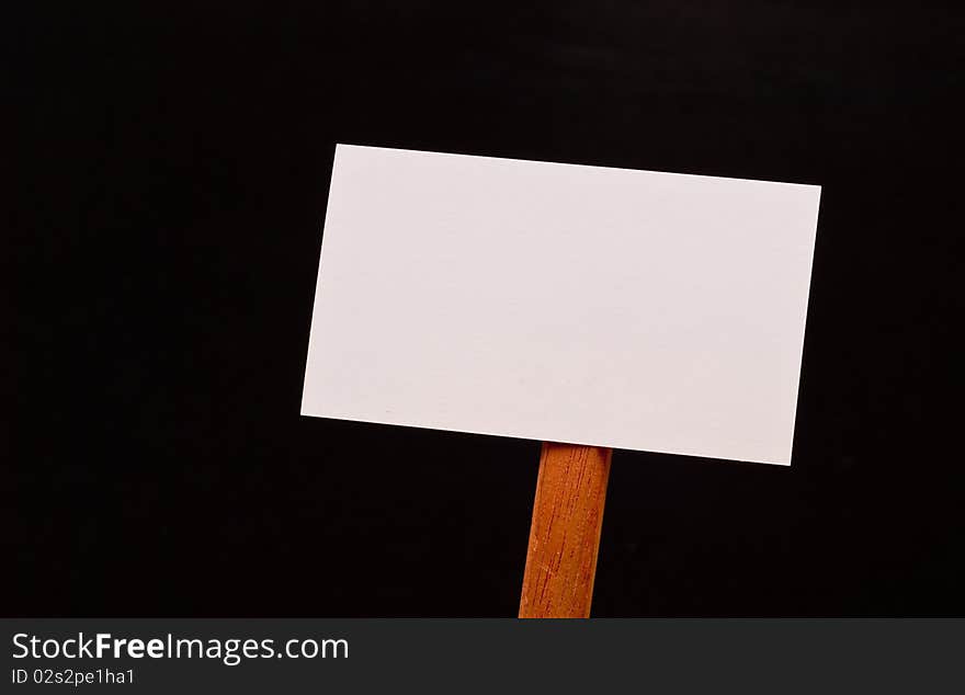 Blank Sign on Wood Stick on Black