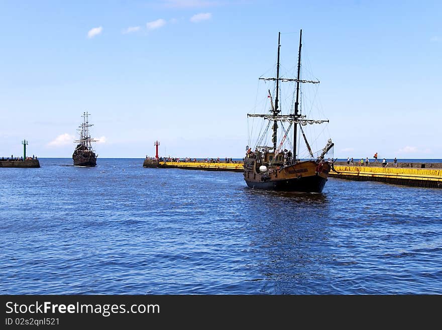 Sailing ship sailing into the port at sea. Sailing ship sailing into the port at sea