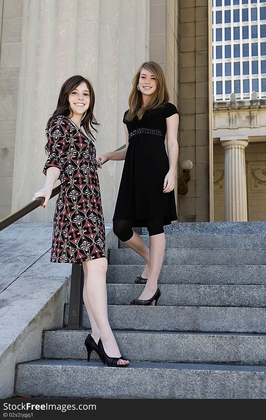 Two young females standing on stairs downtown. Two young females standing on stairs downtown