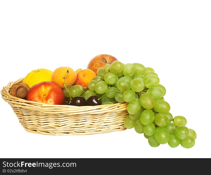 Various fruit in the basket on a white background