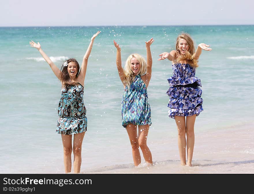 Three happy girls on beach