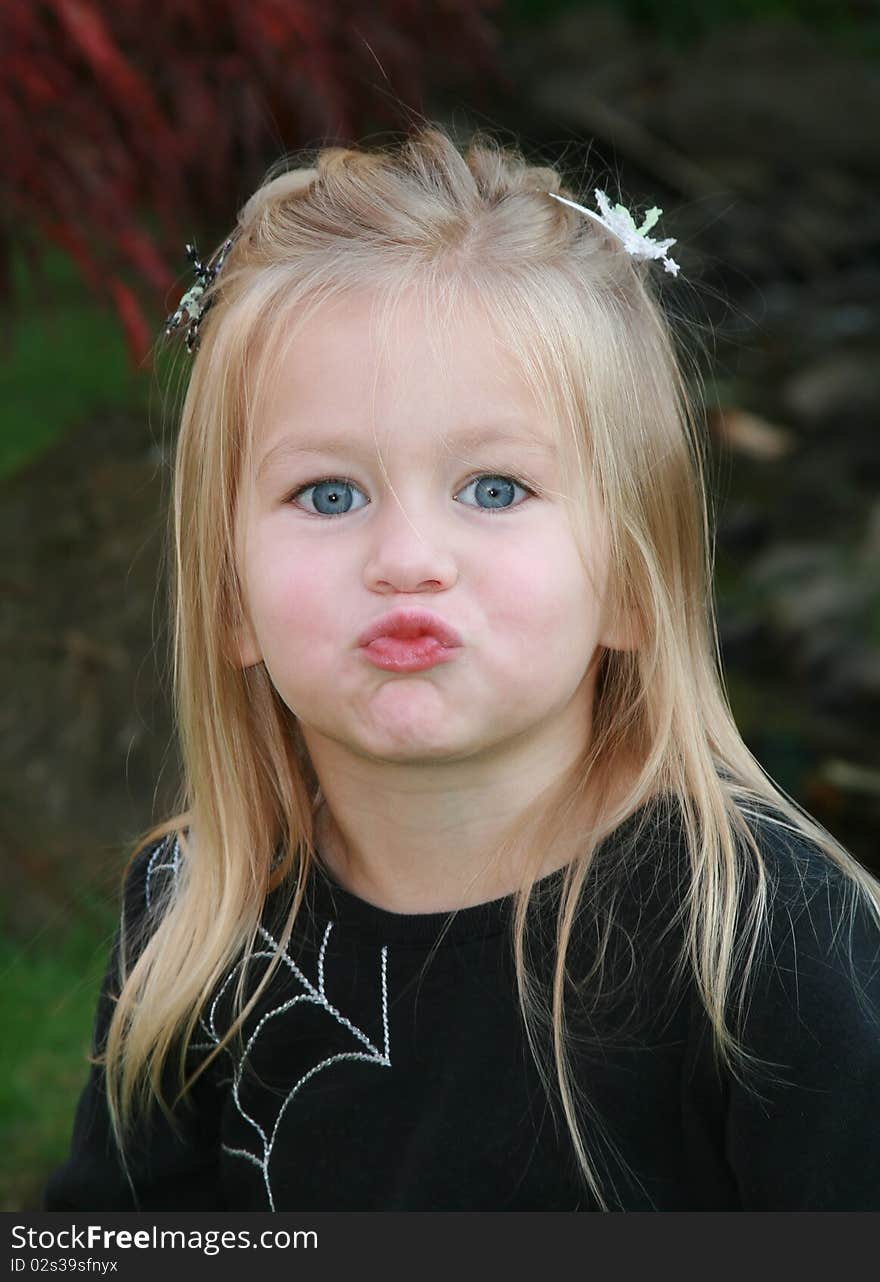 Young girl makes a silly kissy face