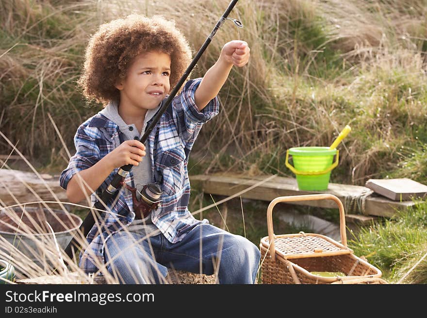 Young Boy Fishing At Seaside