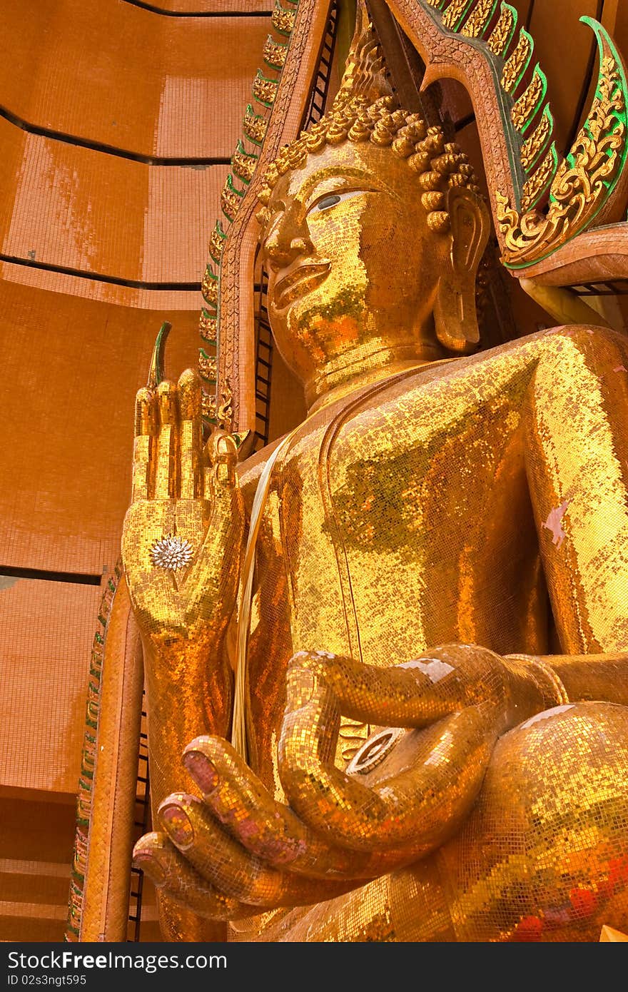 Golden big Buddha statue taken from low angle