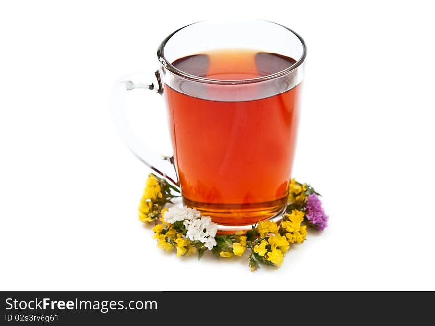 Cup of tea with flowers isolated on white