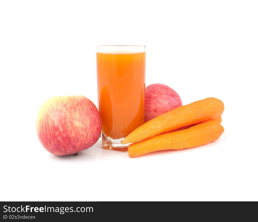 Glass of juice with carrots and apples on a white background