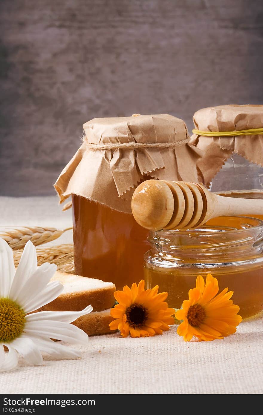 Flowers and honey on table