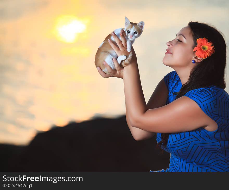 Woman with kitten outdoor at sunrise time. Woman with kitten outdoor at sunrise time