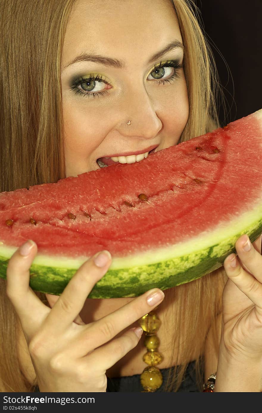 Portrait of a beautiful sexual girl with watermelon in his hands, isolation on a black background. Portrait of a beautiful sexual girl with watermelon in his hands, isolation on a black background