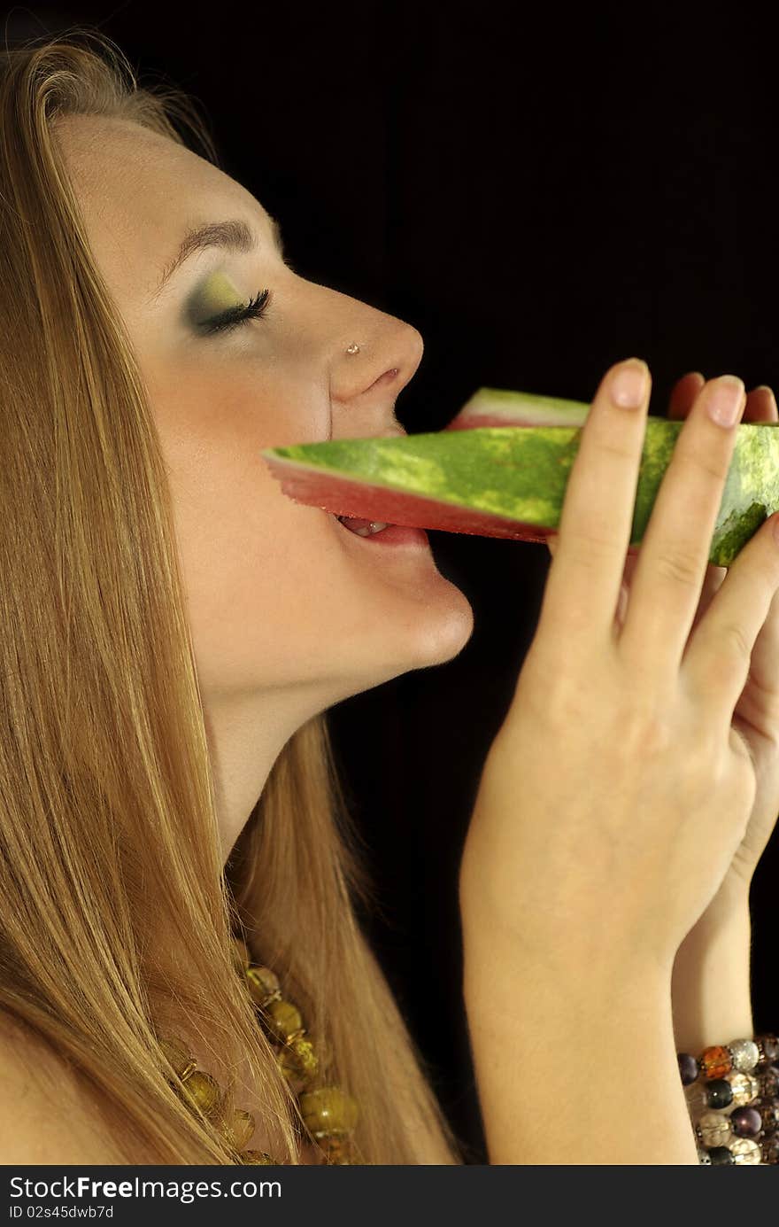 Portrait of a beautiful sexual girl with watermelon in his hands, isolation on a black background. Portrait of a beautiful sexual girl with watermelon in his hands, isolation on a black background