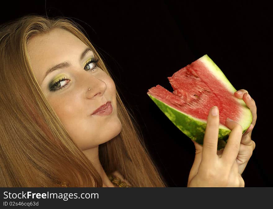 Portrait of a beautiful sexual girl with watermelon in his hands, isolation on a black background. Portrait of a beautiful sexual girl with watermelon in his hands, isolation on a black background