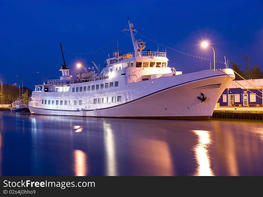 Passenger liner with night by the harbour in the port. Passenger liner with night by the harbour in the port