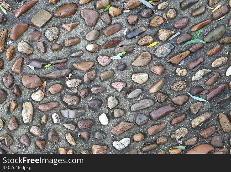 Surface texture of a concrete sidewalk with exposed aggregate. Surface texture of a concrete sidewalk with exposed aggregate