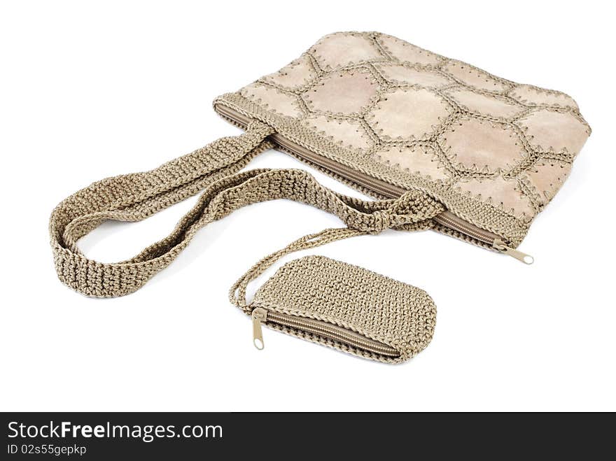 Beige leather bag with knitted elements and wallet. Isolated on white background. Beige leather bag with knitted elements and wallet. Isolated on white background