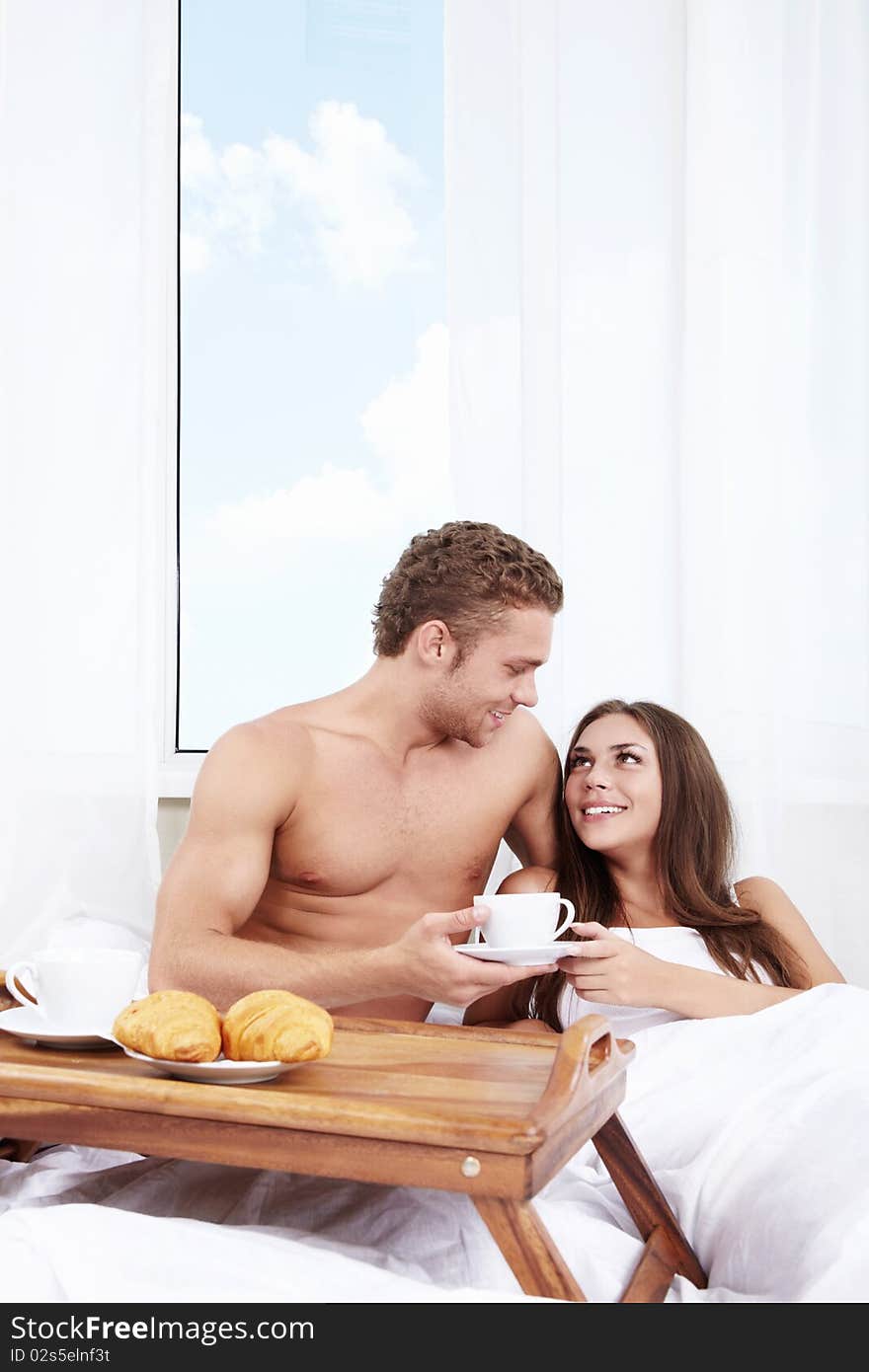 The young man brought breakfast in bed girl. The young man brought breakfast in bed girl