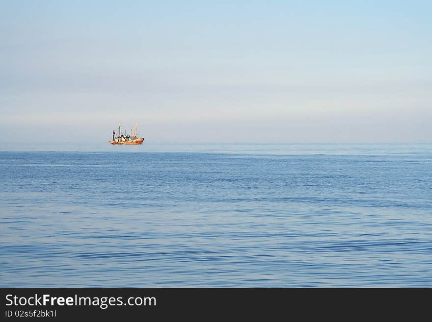 Fishing boats while fishing in the evening sea