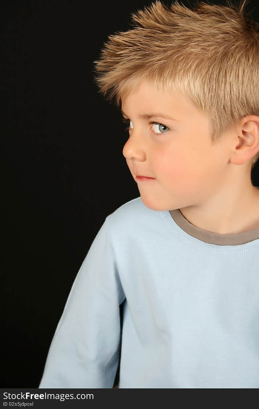 Cute blond boy on a black background. Cute blond boy on a black background