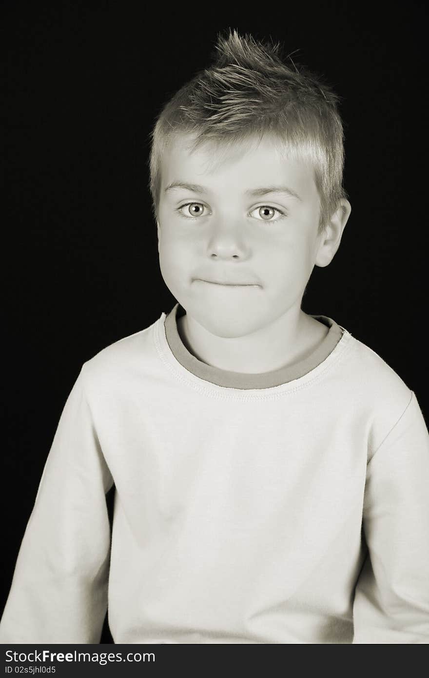 Cute blond boy on a black background. Cute blond boy on a black background