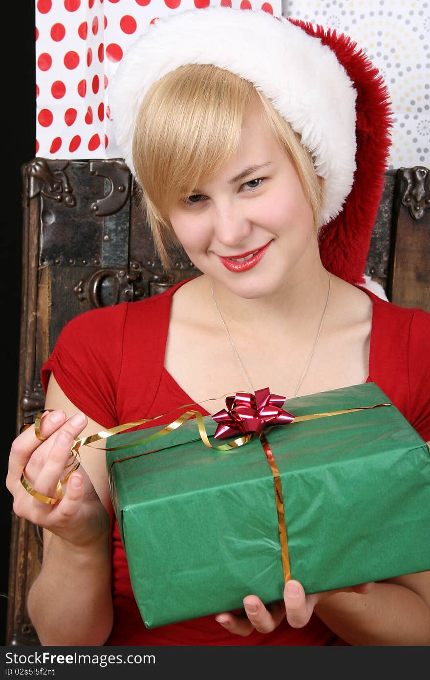 Beautiful blond female holding a christmas present. Beautiful blond female holding a christmas present