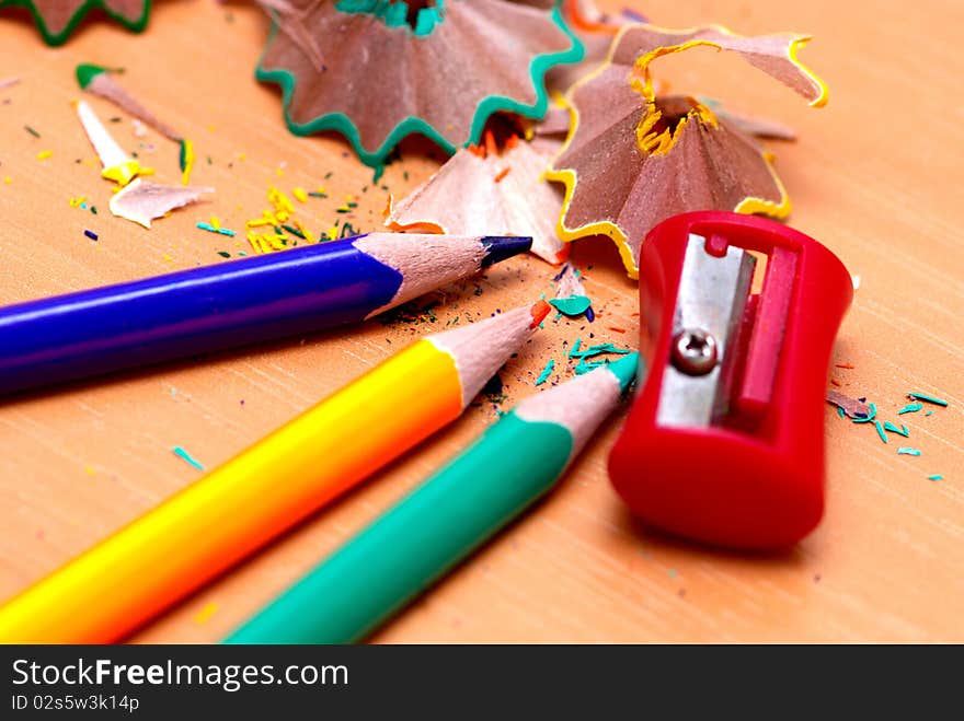 Pencils with a sharpener and shaving on a table