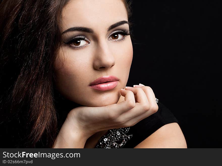 Beautiful fashioned woman on black background