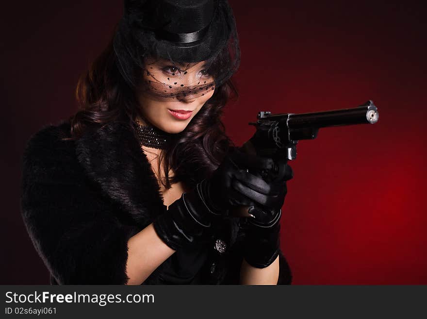 Elegant lady with a pistol