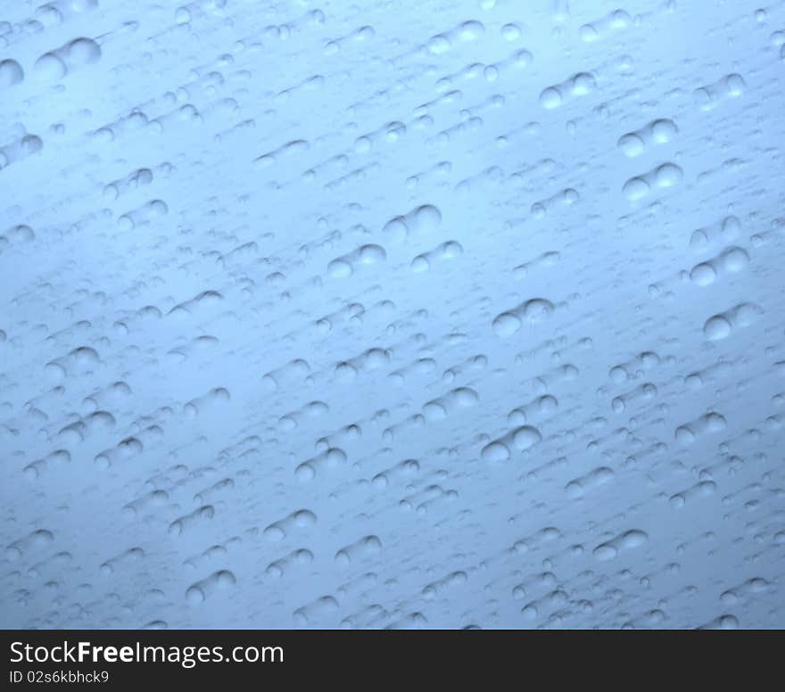 Blurred Raindrops on a Blue Background. Blurred Raindrops on a Blue Background