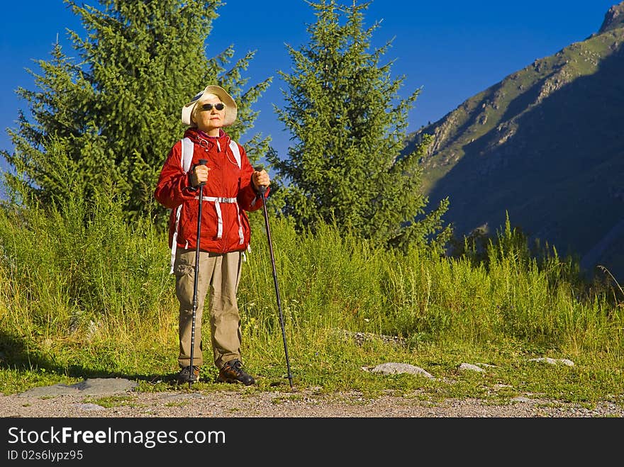 Old woman with mountains flowers. Old woman with mountains flowers