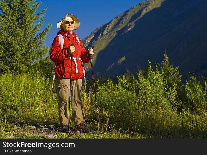 Old woman with mountains flowers. Old woman with mountains flowers