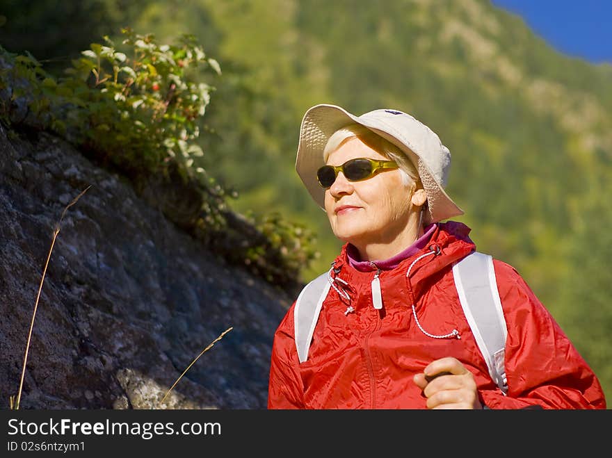 Old woman with mountains flowers. Old woman with mountains flowers