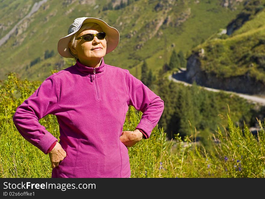 Old woman with mountains flowers. Old woman with mountains flowers