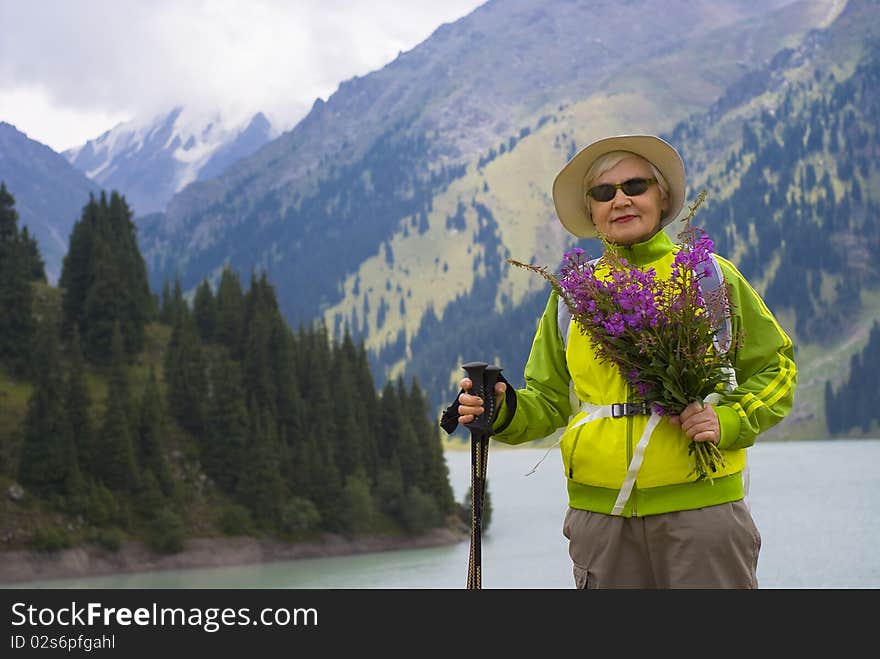 Old woman with mountains flowers. Old woman with mountains flowers