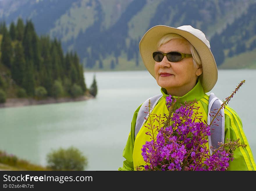 Old woman with mountains flowers. Old woman with mountains flowers